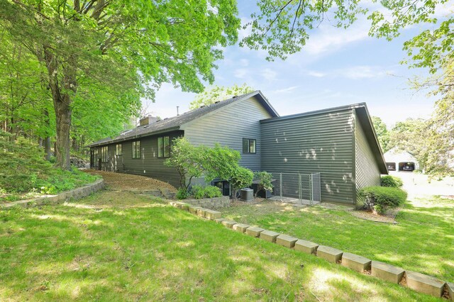 745 Virginia Shores Cir, Victoria, MN 55331 - view of side of home with a yard, central AC unit, and a chimney