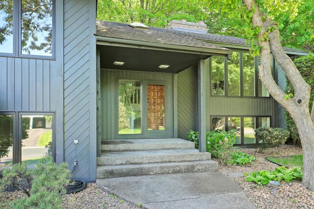 745 Virginia Shores Cir, Victoria, MN 55331 - entrance to property featuring board and batten siding, a chimney, and roof with shingles