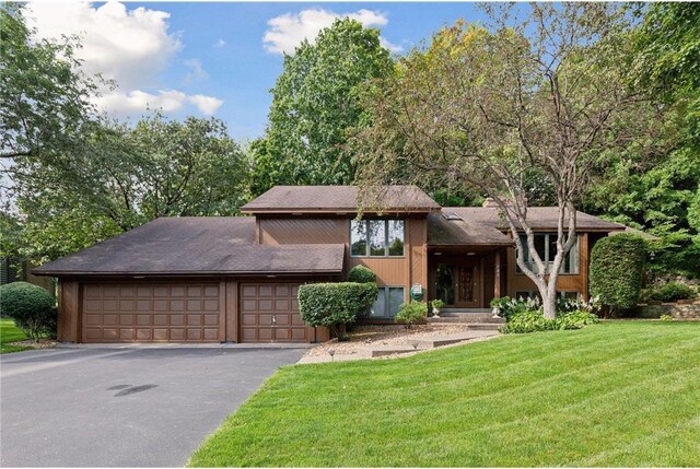 745 Virginia Shores Cir, Victoria, MN 55331 - tri-level home with a front yard, asphalt driveway, and a garage
