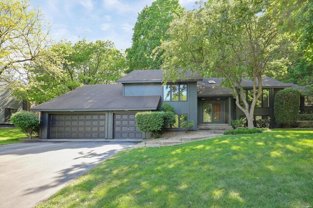 745 Virginia Shores Cir, Victoria, MN 55331 - mid-century inspired home with a front lawn, driveway, and a garage