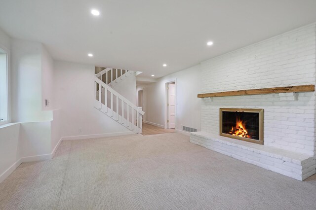 745 Virginia Shores Cir, Victoria, MN 55331 - unfurnished living room featuring carpet floors, a fireplace, stairway, recessed lighting, and baseboards