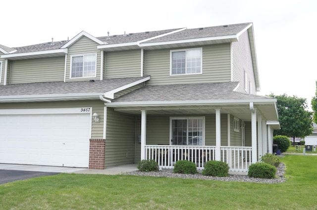 9467 Golden Eagle Ln, Monticello, MN 55362 - view of front of property with a porch, roof with shingles, a front lawn, an attached garage, and asphalt driveway