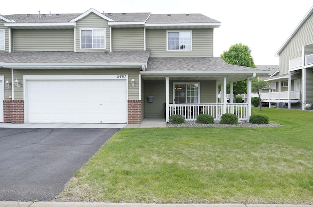 9467 Golden Eagle Ln, Monticello, MN 55362 - view of front of property featuring a porch, a front yard, brick siding, asphalt driveway, and an attached garage