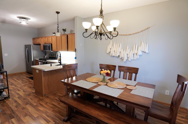 9467 Golden Eagle Ln, Monticello, MN 55362 - dining area with dark wood finished floors, a chandelier, and baseboards