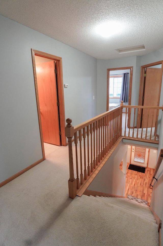 9467 Golden Eagle Ln, Monticello, MN 55362 - stairway featuring carpet floors, a textured ceiling, and baseboards