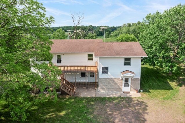 1231 135th St, Amery, WI 54005 - rear view of property featuring a patio, a deck, a yard, roof with shingles, and stairs