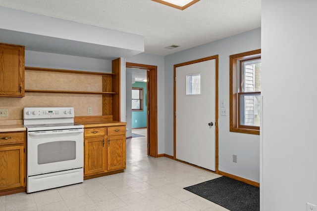 1231 135th St, Amery, WI 54005 - kitchen with white electric range, open shelves, light countertops, brown cabinets, and a textured ceiling
