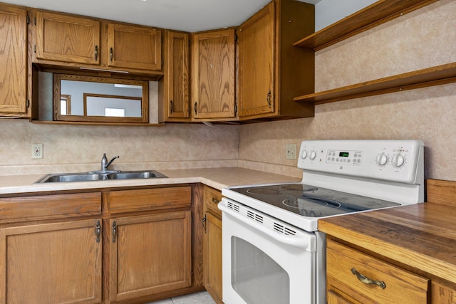1231 135th St, Amery, WI 54005 - kitchen featuring white range with electric stovetop, open shelves, brown cabinetry, and decorative backsplash