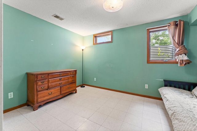 1231 135th St, Amery, WI 54005 - bedroom with multiple windows and a textured ceiling