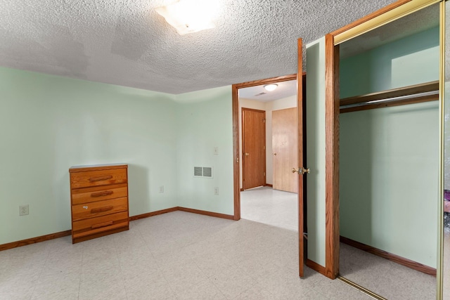 1231 135th St, Amery, WI 54005 - unfurnished bedroom with a closet and a textured ceiling