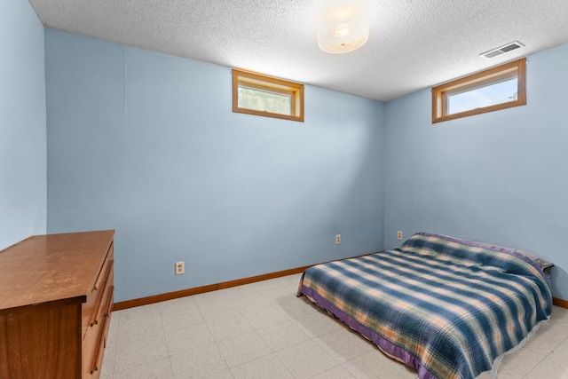 1231 135th St, Amery, WI 54005 - bedroom featuring a textured ceiling and baseboards