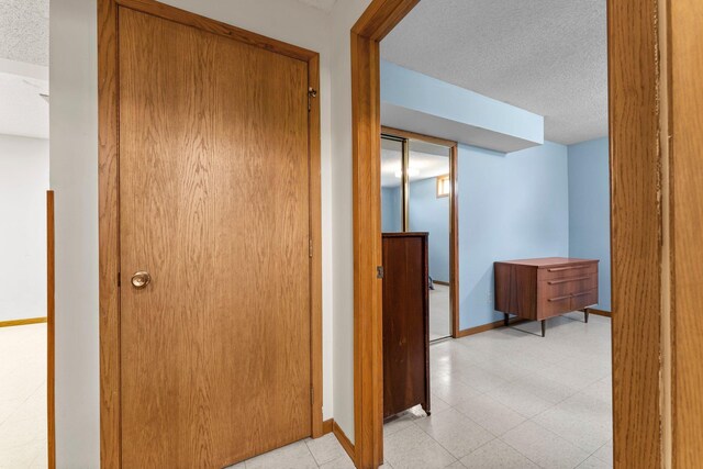 1231 135th St, Amery, WI 54005 - corridor with a textured ceiling and baseboards