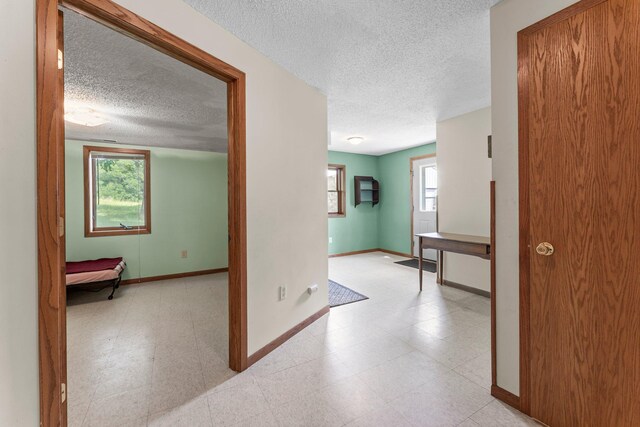 1231 135th St, Amery, WI 54005 - hall with a textured ceiling and light floors
