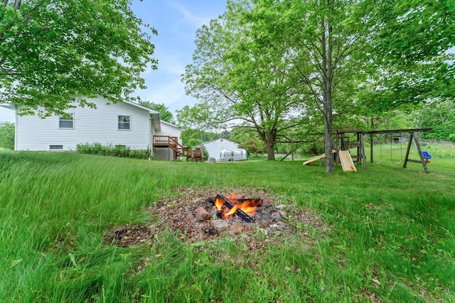 1231 135th St, Amery, WI 54005 - view of grassy yard with a fire pit and a playground