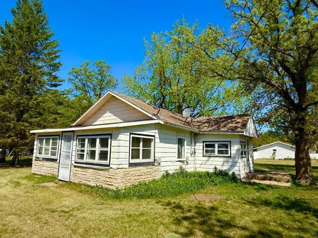 65 6th Ave S, Motley, MN 56466 - view of front of home featuring stone siding and a front yard
