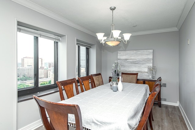 207 5th Ave SW Unit 901, Rochester, MN 55902 - dining area featuring a chandelier, wood finished floors, plenty of natural light, baseboards, and crown molding