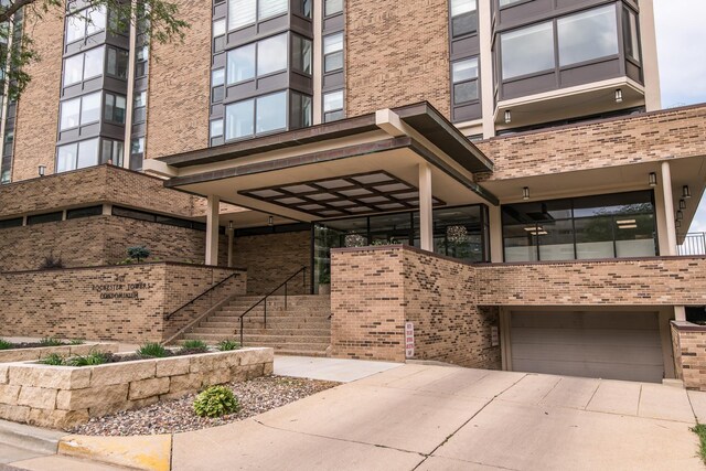 207 5th Ave SW Unit 901, Rochester, MN 55902 - property entrance with brick siding, a garage, and driveway