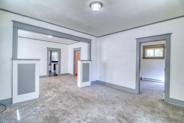 1010 University Dr N, Fargo, ND 58102 - unfurnished living room featuring baseboard heating, carpet, and baseboards