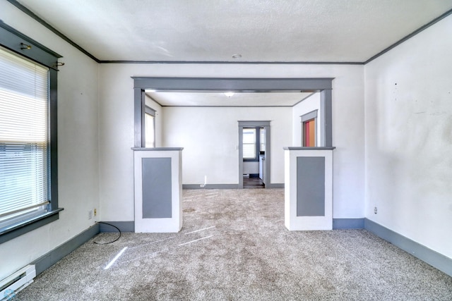 1010 University Dr N, Fargo, ND 58102 - carpeted empty room featuring a baseboard heating unit, baseboards, and ornamental molding