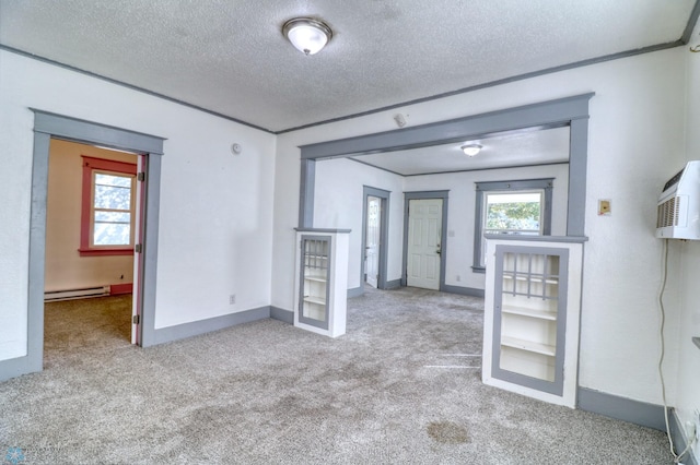 1010 University Dr N, Fargo, ND 58102 - carpeted empty room with a baseboard radiator, a textured ceiling, and baseboards