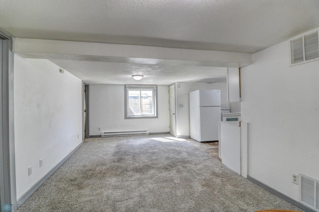 1010 University Dr N, Fargo, ND 58102 - unfurnished room featuring baseboard heating, light carpet, a textured ceiling, and baseboards