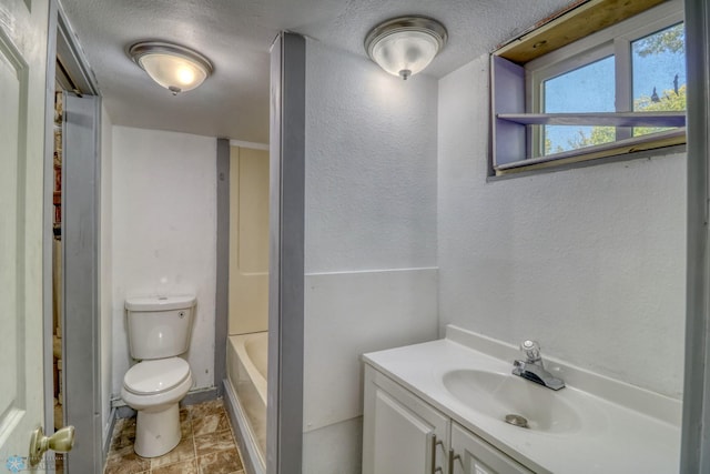 1010 University Dr N, Fargo, ND 58102 - full bathroom featuring toilet, vanity, a textured wall, and a textured ceiling