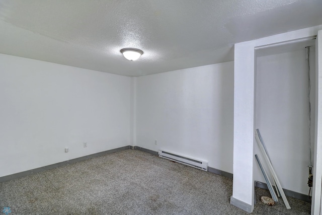 1010 University Dr N, Fargo, ND 58102 - carpeted spare room with baseboard heating, a textured ceiling, and baseboards