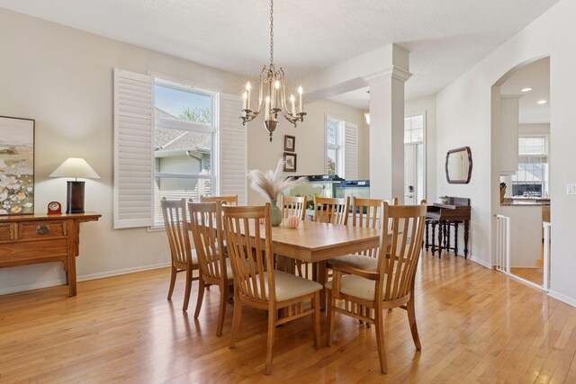 4555 Jewel Ln N, Plymouth, MN 55446 - dining area featuring light wood finished floors, baseboards, arched walkways, a chandelier, and recessed lighting