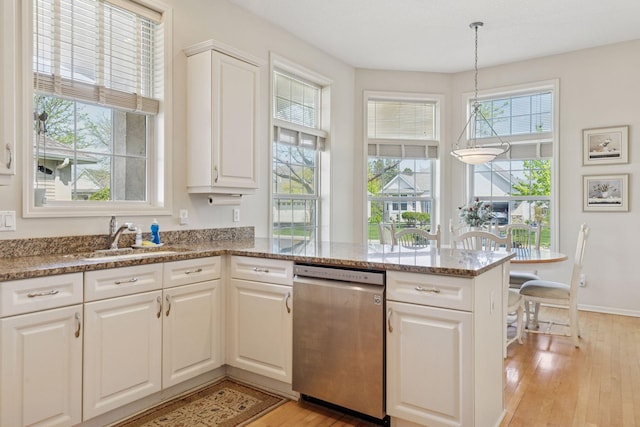 4555 Jewel Ln N, Plymouth, MN 55446 - kitchen with stainless steel dishwasher, a sink, light wood finished floors, a peninsula, and white cabinetry