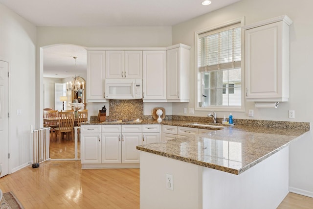 4555 Jewel Ln N, Plymouth, MN 55446 - kitchen featuring white appliances, a sink, white cabinetry, light wood finished floors, and light stone counters