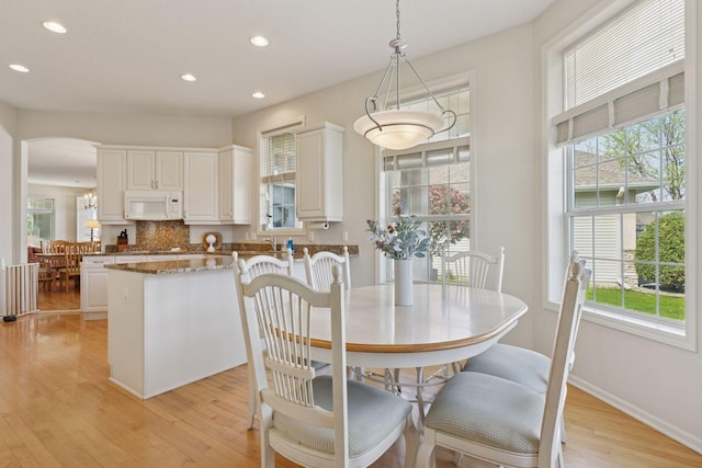 4555 Jewel Ln N, Plymouth, MN 55446 - dining space featuring plenty of natural light, recessed lighting, light wood-style floors, baseboards, and arched walkways
