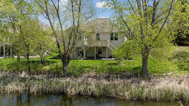 4555 Jewel Ln N, Plymouth, MN 55446 - rear view of house featuring a deck with water view, stairs, and a yard
