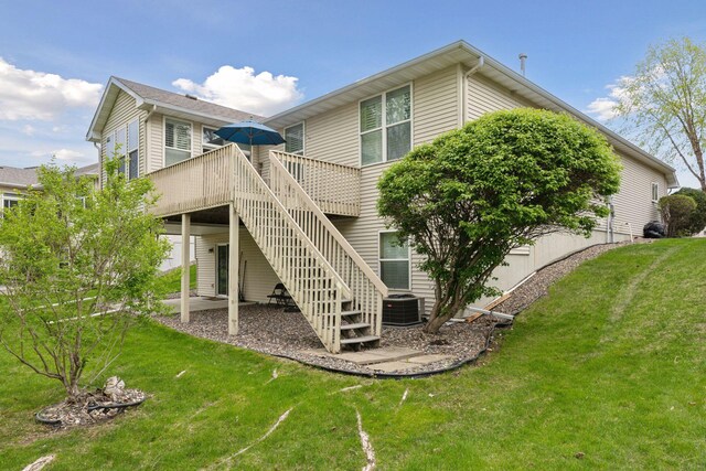 4555 Jewel Ln N, Plymouth, MN 55446 - back of house featuring a wooden deck, a yard, and central AC unit