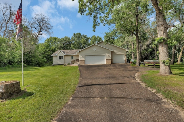 16474 63rd St SE, Becker, MN 55308 - view of front of home featuring asphalt driveway, a front lawn, an attached garage, and brick siding