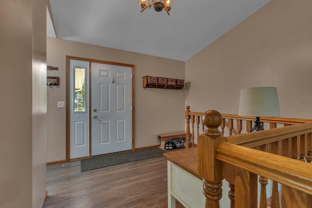 16474 63rd St SE, Becker, MN 55308 - foyer entrance with a chandelier, wood finished floors, and vaulted ceiling