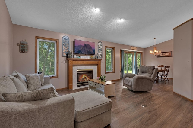 16474 63rd St SE, Becker, MN 55308 - living room featuring a chandelier, a textured ceiling, wood finished floors, a tile fireplace, and lofted ceiling