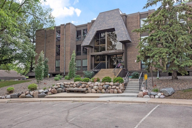 6085 Lincoln Dr Unit 123, Edina, MN 55436 - view of building exterior featuring stairs and uncovered parking