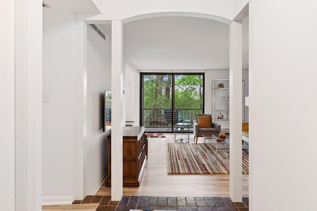 6085 Lincoln Dr Unit 123, Edina, MN 55436 - hallway with arched walkways, wood finished floors, and floor to ceiling windows