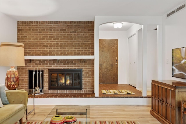 6085 Lincoln Dr Unit 123, Edina, MN 55436 - living area with wood finished floors, a brick fireplace, and arched walkways