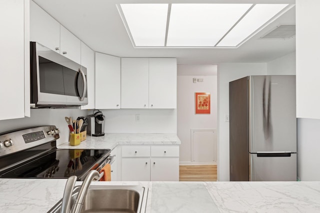 6085 Lincoln Dr Unit 123, Edina, MN 55436 - kitchen with stainless steel appliances, white cabinetry, and a sink