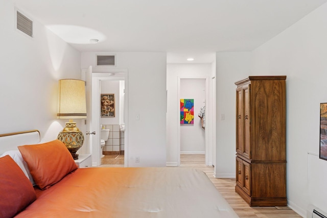 6085 Lincoln Dr Unit 123, Edina, MN 55436 - bedroom with a baseboard heating unit, light wood-type flooring, baseboards, recessed lighting, and connected bathroom