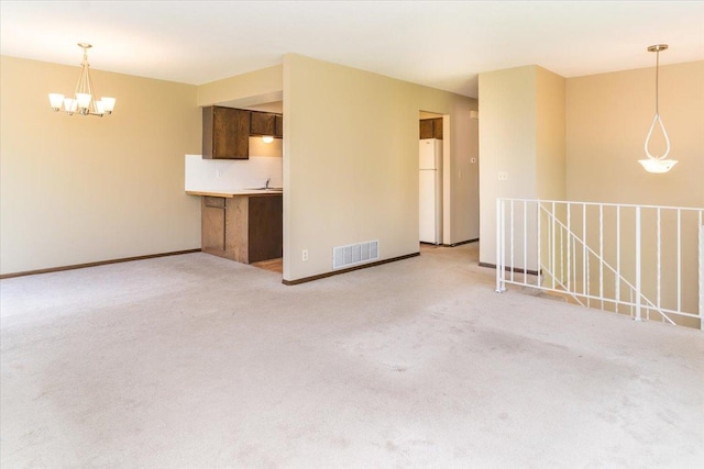 10382 Juniper Ln, Eden Prairie, MN 55347 - unfurnished living room featuring a chandelier and light carpet