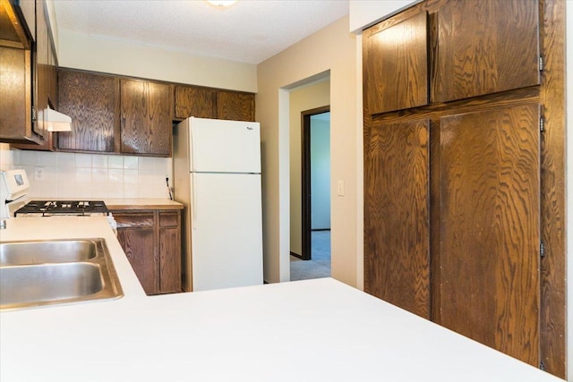 10382 Juniper Ln, Eden Prairie, MN 55347 - kitchen featuring white appliances, light countertops, extractor fan, and backsplash