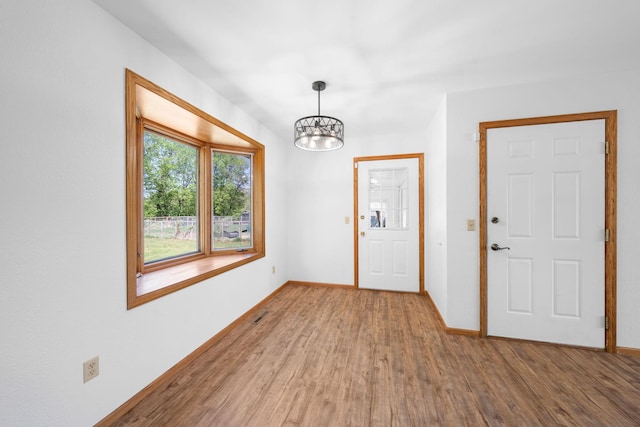 39094 Riverside Ct, North Branch, MN 55056 - entryway featuring a chandelier, wood finished floors, and baseboards