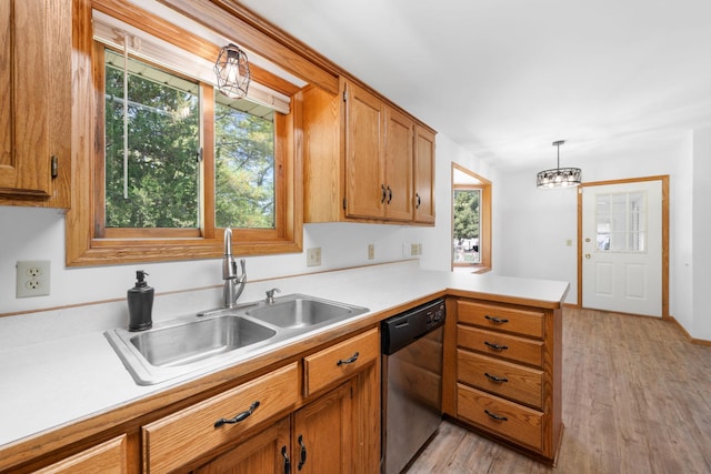 39094 Riverside Ct, North Branch, MN 55056 - kitchen featuring stainless steel dishwasher, a sink, a peninsula, and light countertops