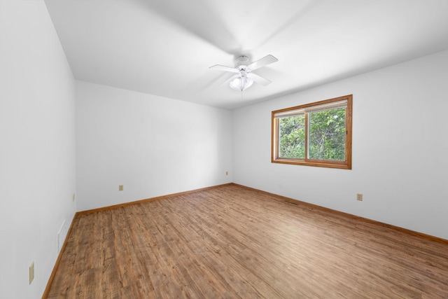39094 Riverside Ct, North Branch, MN 55056 - spare room featuring wood finished floors, ceiling fan, and baseboards