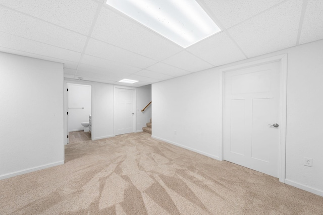 39094 Riverside Ct, North Branch, MN 55056 - finished below grade area with light carpet, a drop ceiling, stairs, and baseboards