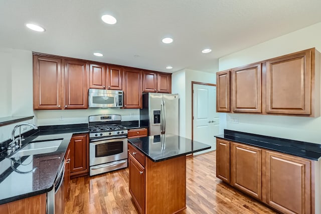 1595 Fox Hunt Way, Victoria, MN 55386 - kitchen with stainless steel appliances, a sink, light wood-style flooring, a kitchen island, and recessed lighting