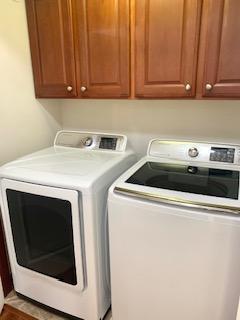 1595 Fox Hunt Way, Victoria, MN 55386 - clothes washing area featuring separate washer and dryer and cabinet space