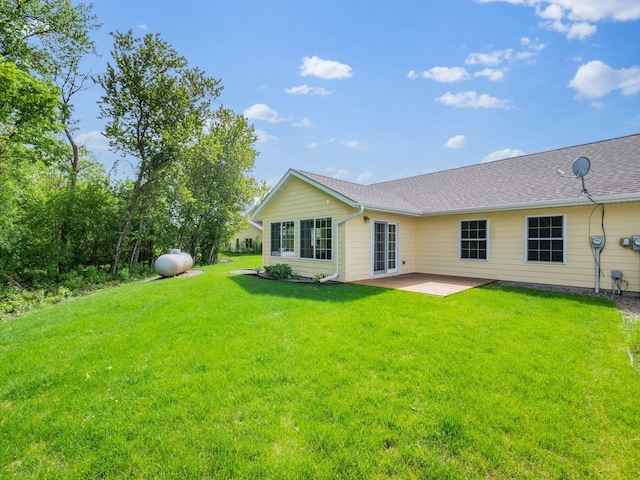 116 Street Cir Unit 104, Miltona, MN 56354 - back of house featuring a patio area, a lawn, and a shingled roof